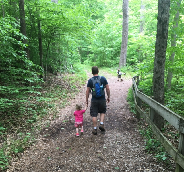 my two kids and husband on a forest trail